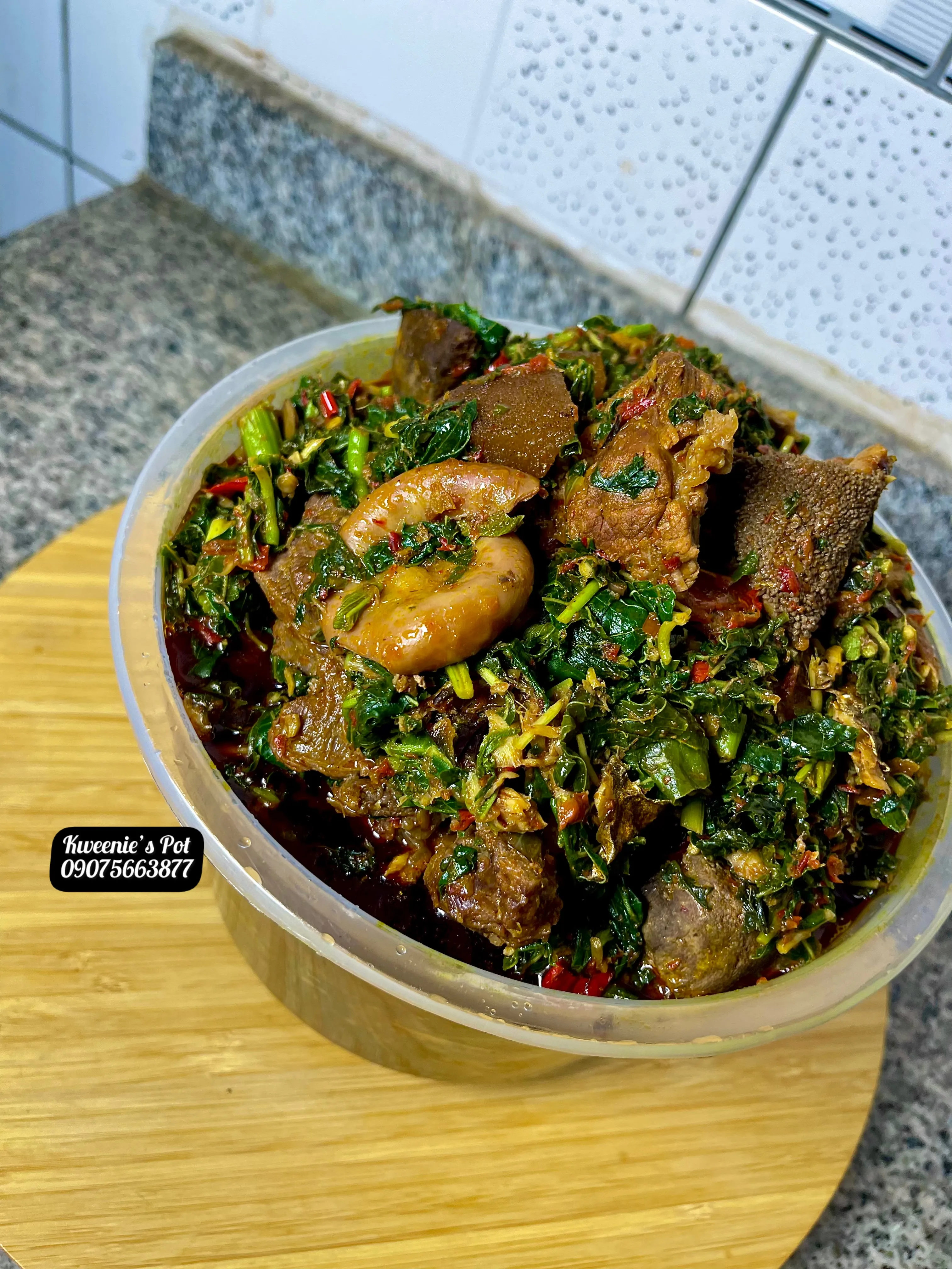 Efo riro vegetable soup in a wooden bowl