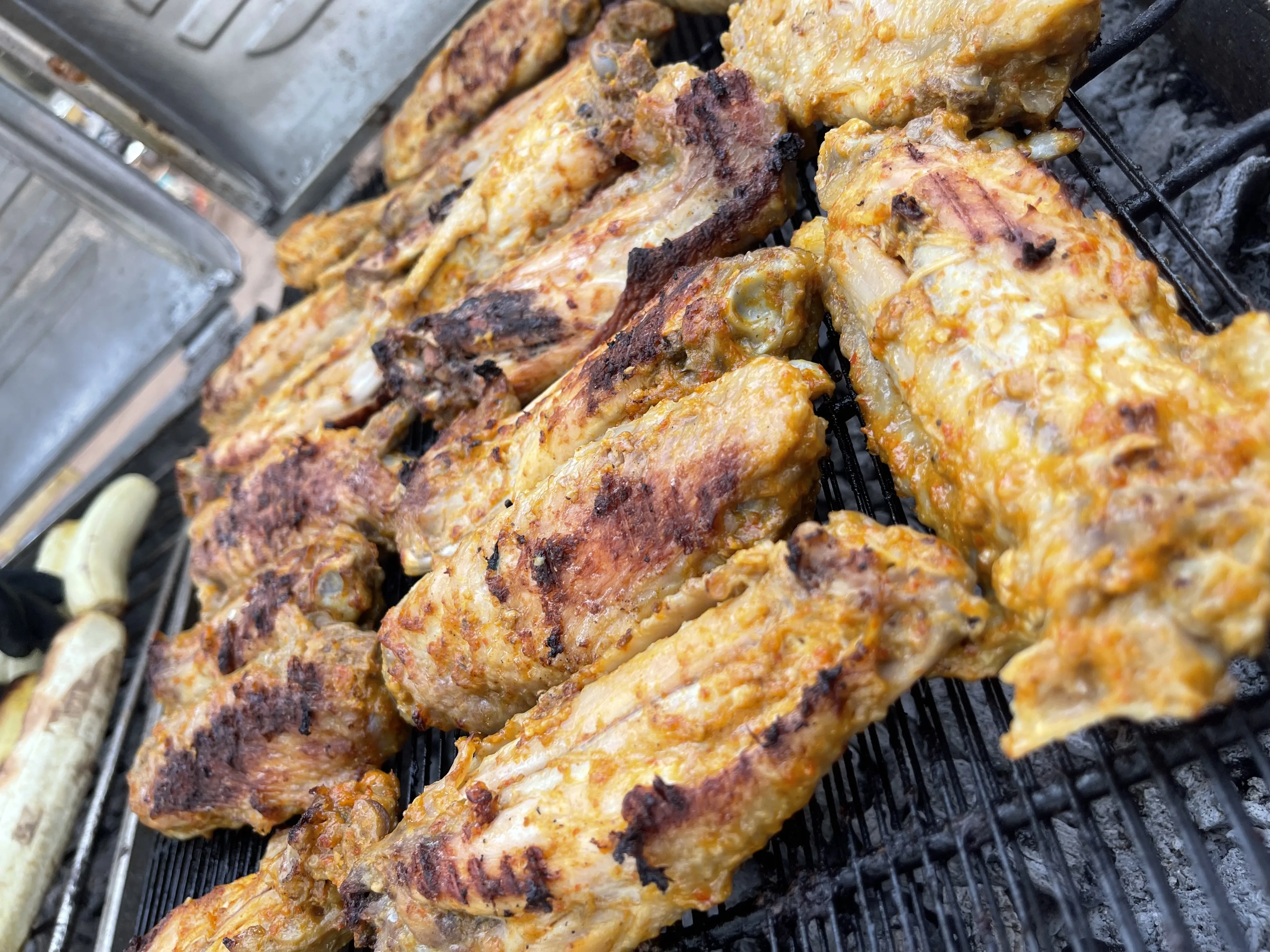 Grilled chicken wings closeup on charcoal grill