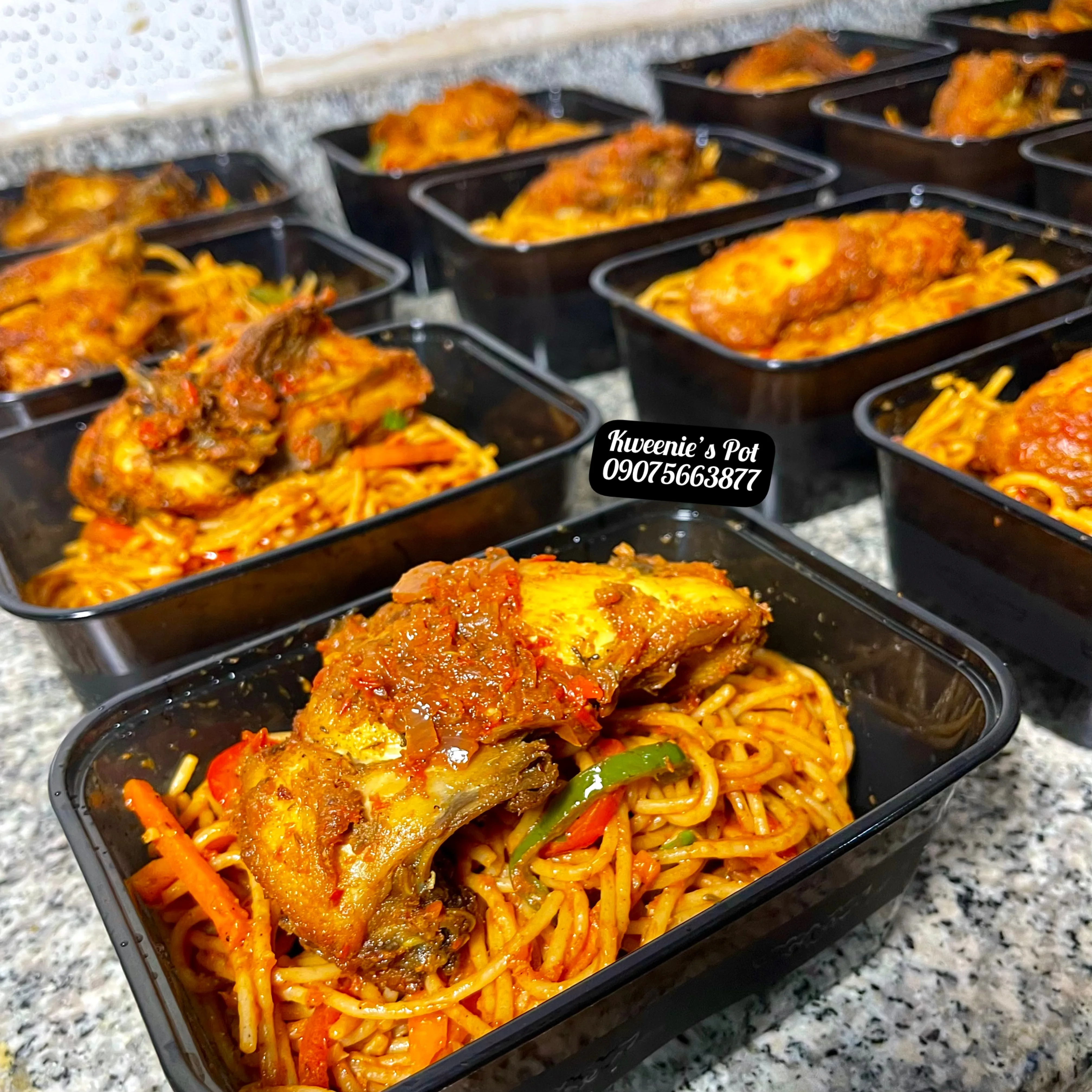 Closeup of jollof spaghetti with peppered chicken