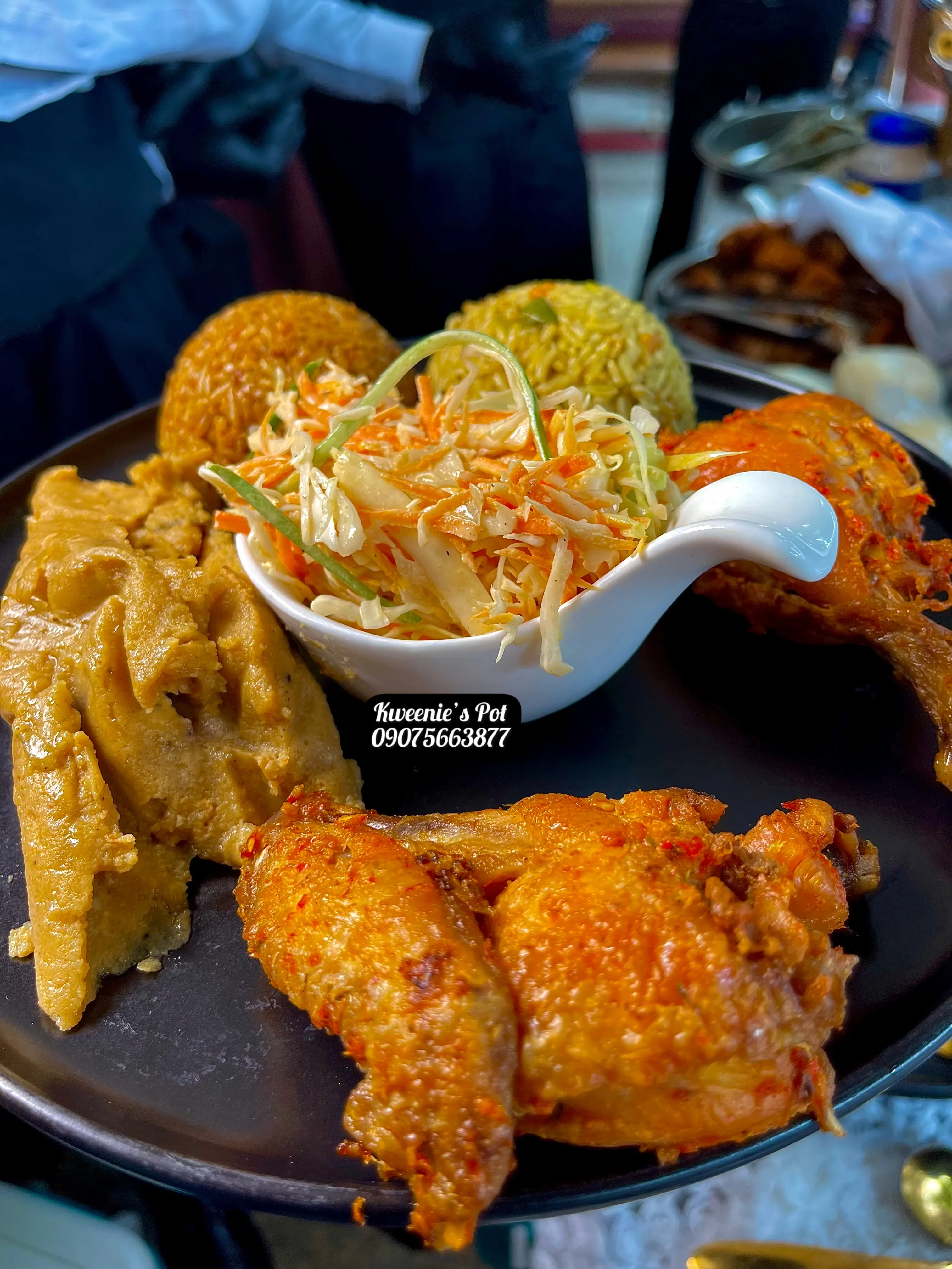 Nigerian plate with fried chicken, rice, and fresh coleslaw